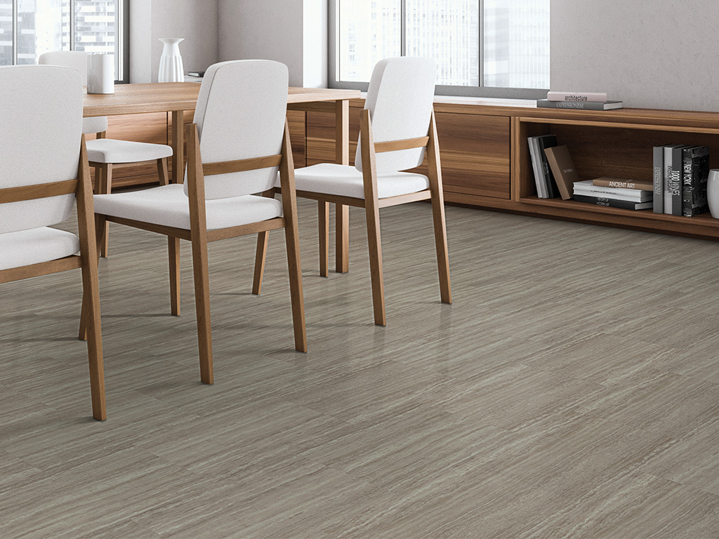 Strata Graphite luxury vinyl tile installed in a modern office setting, featuring cool gray travertine-inspired visuals with subtle linear movement and a clean, contemporary aesthetic.