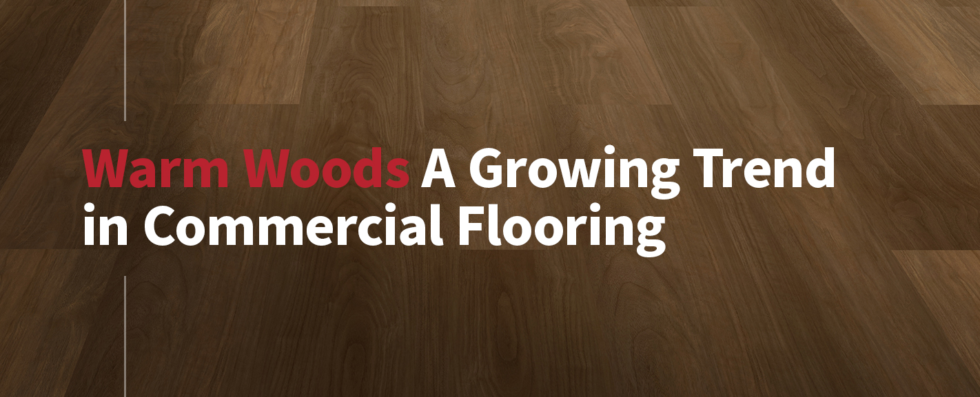 Banner image featuring warm brown wood-look commercial LVT flooring with the headline “Warm Woods: A Growing Trend in Commercial Flooring.”
